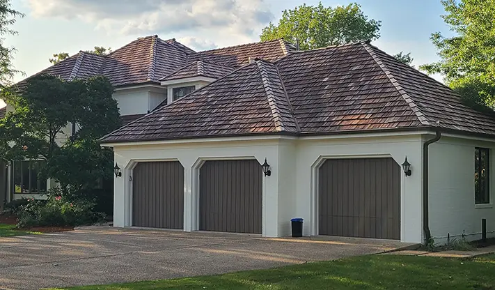 Halfway complete brick staining project, white stain on brick house by Klasek Painting